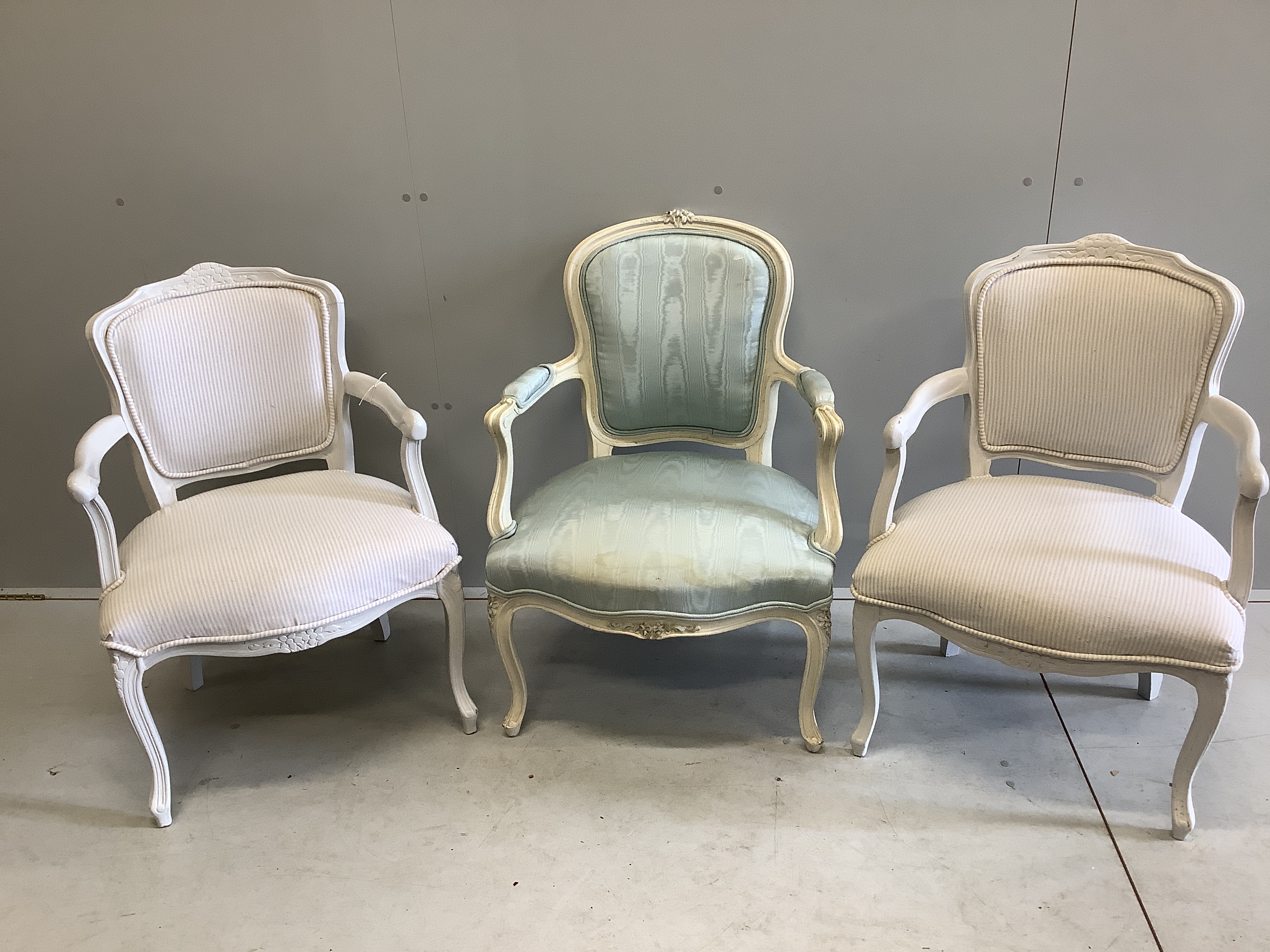 A pair of French style painted fauteuil, width 58cm, depth 48cm, height 80cm together with one other similar chair